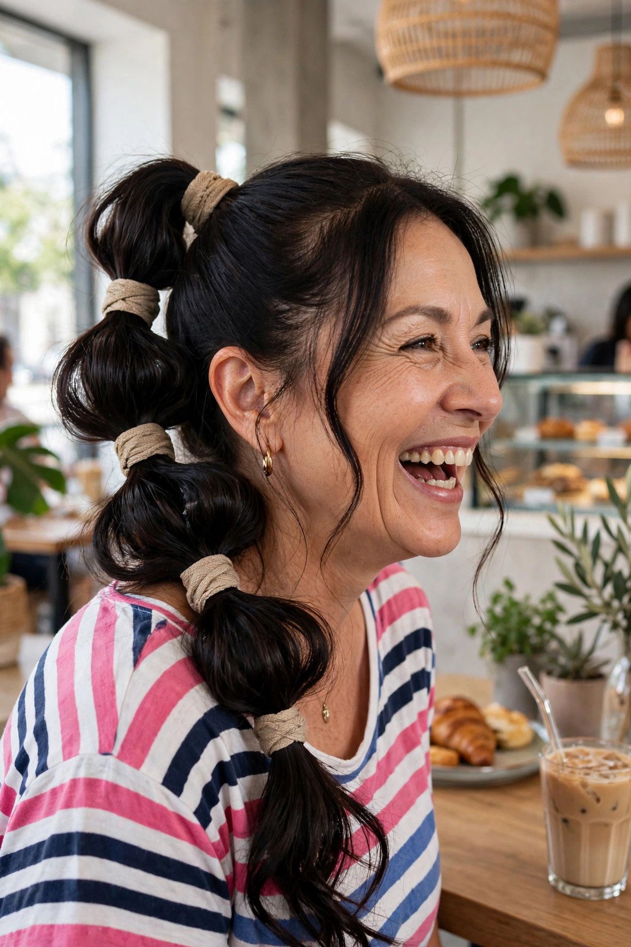 Playful bubble ponytail with wrapped sections on long dark hair
