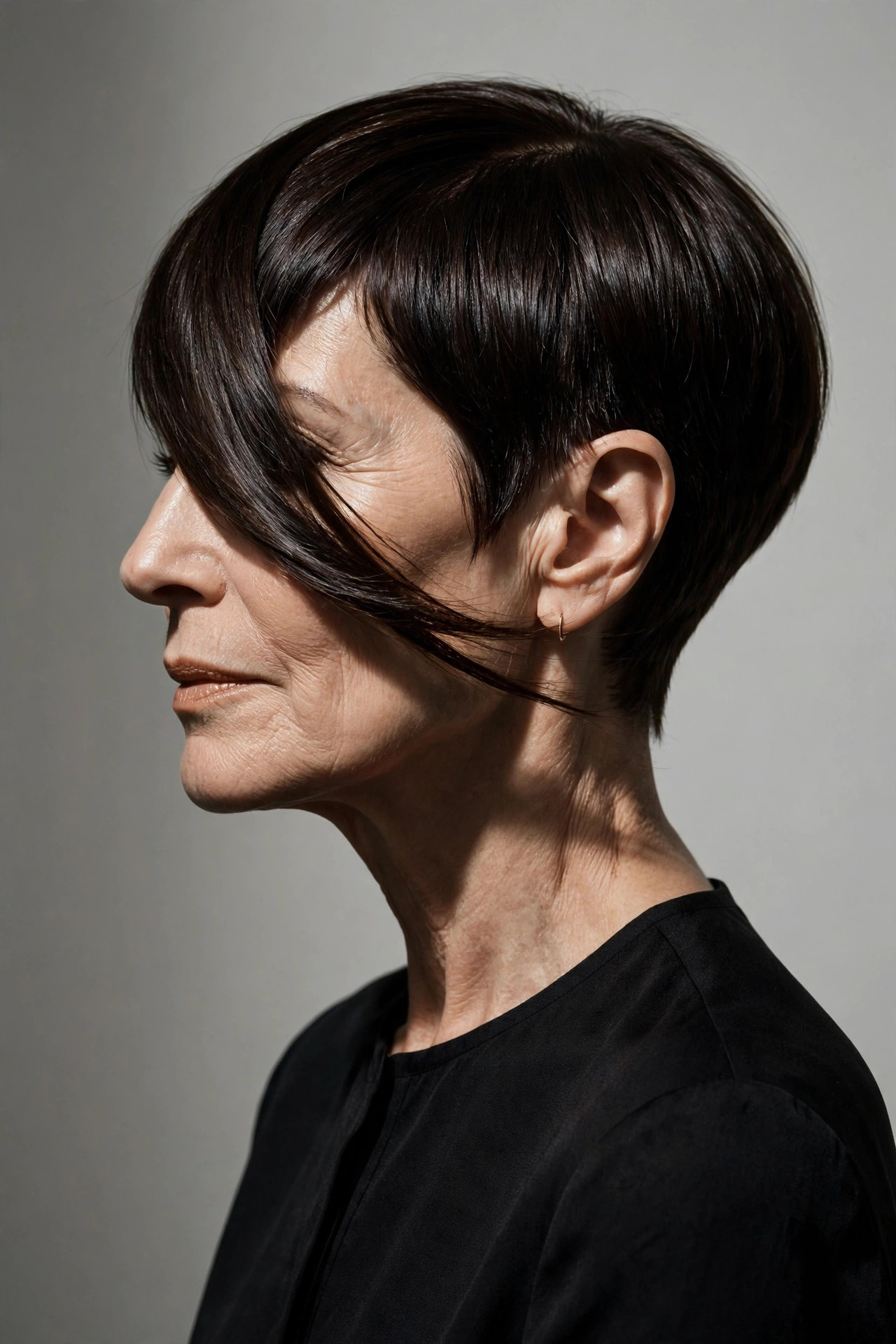 Asymmetrical pixie with clipped side and long sweep, one of the boldest short pixie haircuts for older women